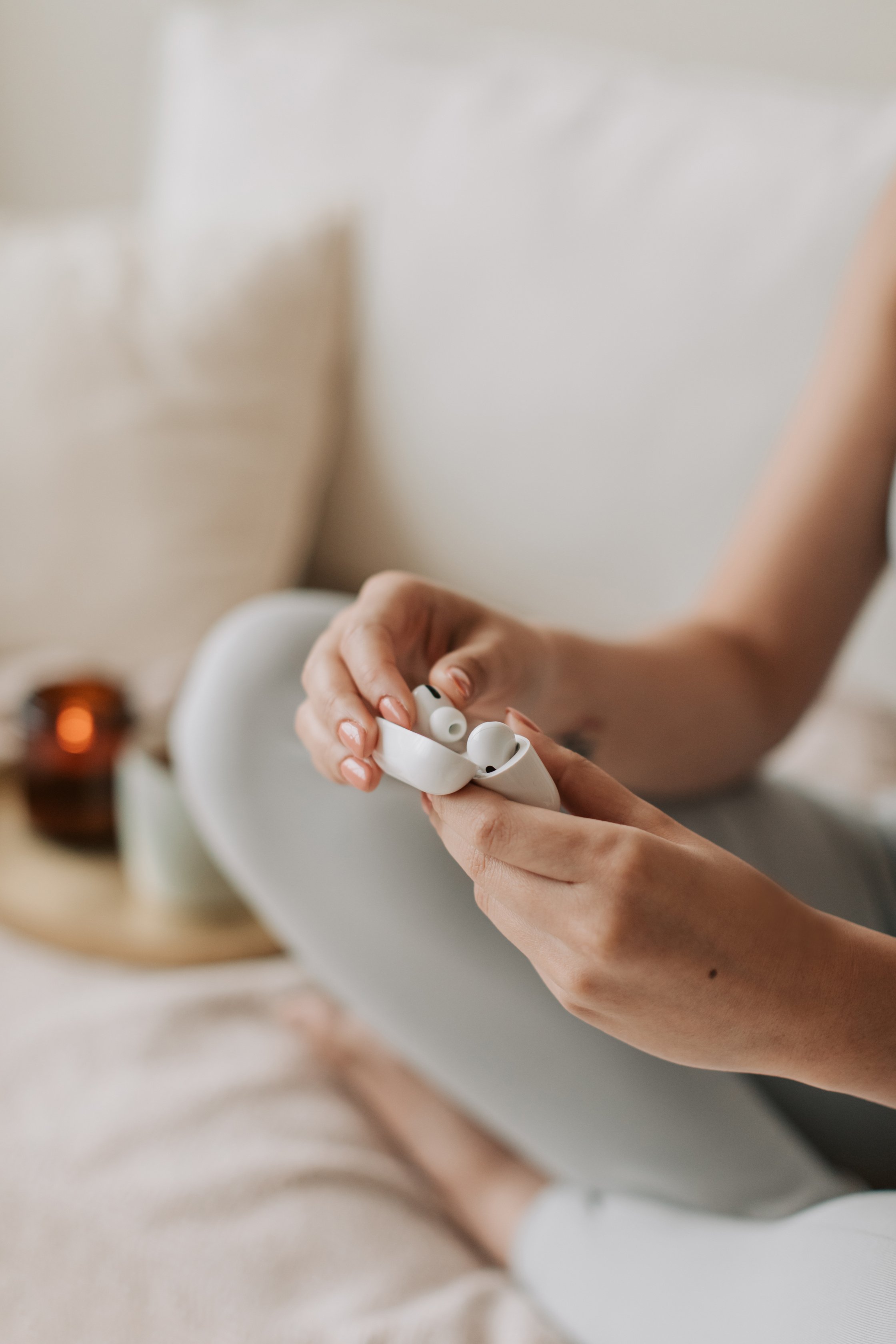 Woman Putting on Wireless Earphones